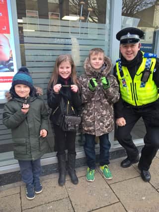 PCSO Ash Hill hands out some of the Drop The Knife wristbands.