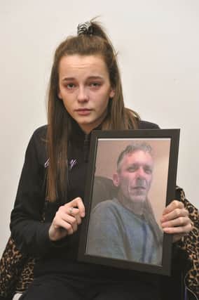 Bethany Dainty with a picture of her missing dad Richard Dyson