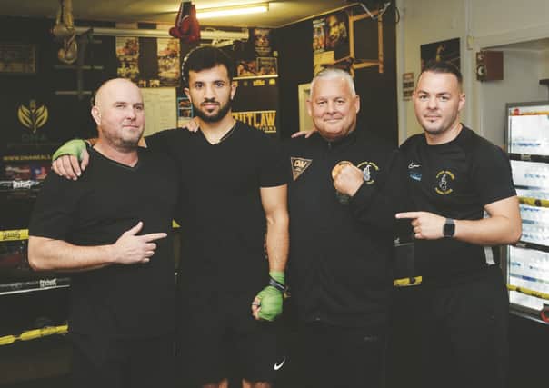 Redwan Nishat with (from left to right) trainer Ian Baines, Mick Wale and Josh Wale.