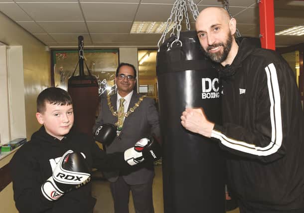 The Mayor of Rotherham, Cllr Tajamal Khan with DC Boxing head coach, Ian Huddlestone and young boxer, Caleb Wharton. 230017-3