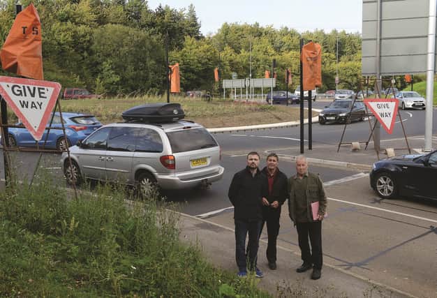 Parish councillor Paul Martin (left) with local residents Adrian Thrower (centre) and Alan Rowles at the problem traffic lights at the roundabout on the A57. 171567-2