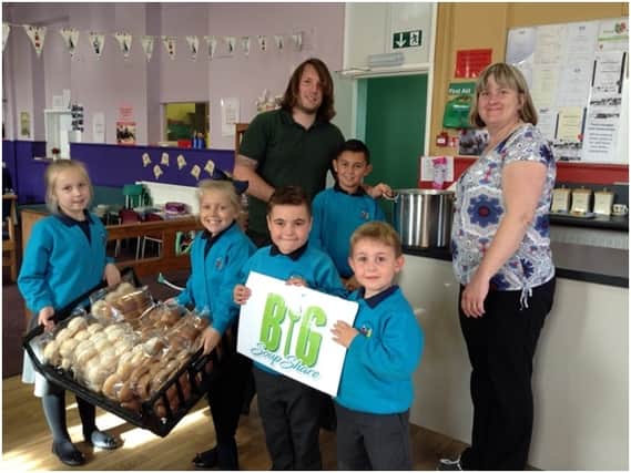 Outdoor education teacher Christopher Wharton-Lovett (back right) and foodbank manager Alison Sykes (right) with Goldthorpe Primary pupils Lucas Cooper, Stan Lee, Tailor-May Mellor, Lainey Crossland and Joshua Mellor.