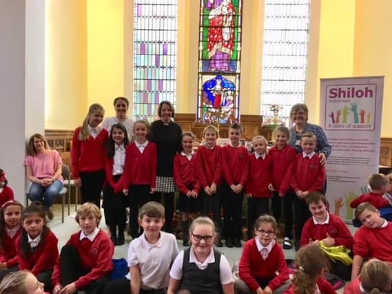 Caption: Children from Thorpe Hesley Primary School with Vicar of Thorpe Hesley Rev Lynn Broadhead (fifth from left) and (right) Shiloh volunteer Jayne Spaven.