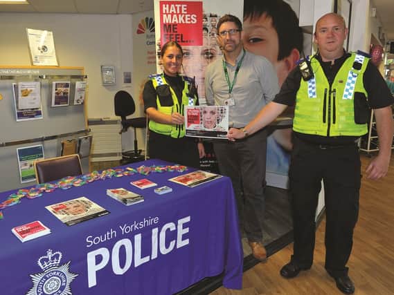 As part of Hate Crime Awareness Week, South Yorkshire Police had a stall at Community Corner in Rotherham Hospital, to make the public aware of the topic. Seen at the stall (left to right) are: PCSO Abby Grzesiek, Tony Bennett, Rotherham Hospital Lead for 'Time To Speak Up' and PCSO Niall Ellison. 184440-2