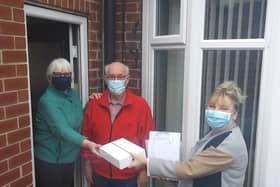 Christine Barnes from Crossroads Care is pictured delivering a wellbeing pack and iPad to carer Ina Kearney and her husband Bob of Swinton, who has dementia to help keep in touch with friends and family.