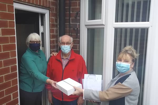 Christine Barnes from Crossroads Care is pictured delivering a wellbeing pack and iPad to carer Ina Kearney and her husband Bob of Swinton, who has dementia to help keep in touch with friends and family.