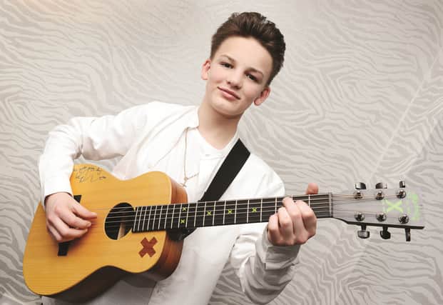 Alfie Sheard with the Ed Sheeran signed guitar given to him when he appeared of the Ellen DeGeneres show in America