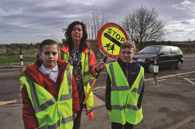 Junior road safety officers at Laughton Junior and Infant School, Sophie Bell and Cairo Hopewell along with learning mentor, Anne-Marie Brammer, who are heading a campaign to try and get sponsorship to fund a new crossing patrol at the school after theirs was removed due to council cuts. 170379-4