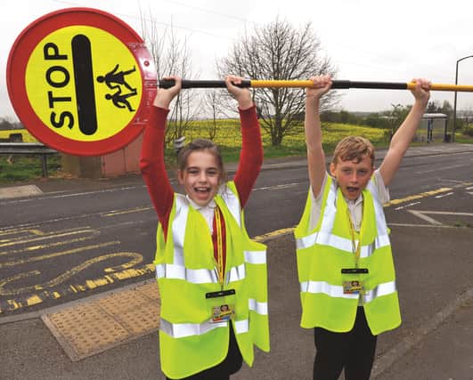You'll never walk alone-we've done it, Laughton Primary School junior road safety officers, Cairo Hopewell and Sophie Bell celebrate the news that their crossing patrol has received enough donations to continue for another year. 170580-1