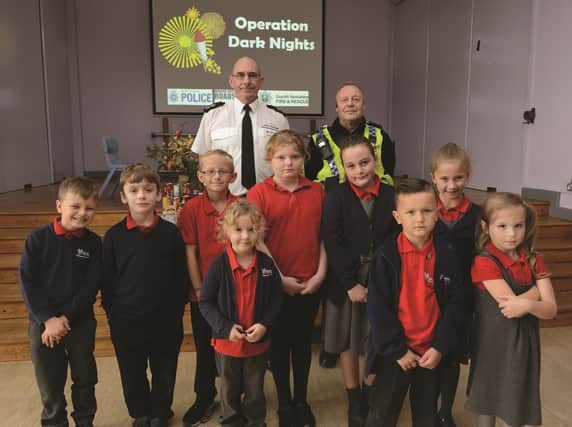 Community safety watch manager for South Yorkshire Fire and Rescue Gary Willoughby (left) and Maltby PCSO Glyn Athersych are pictured with pupils during their recent visit to Maltby Manor Academy. 171746-1