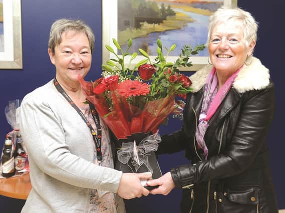 Winner of the Advertiser Valentines Day Flowers winner, Jackie McGrath, is seen being presented with her bouquet from Judy McHale, newspaper sales manager. The flowers were donated by Heritage Bouquets by Michelle, High Street, Goldthorpe. 180240-3