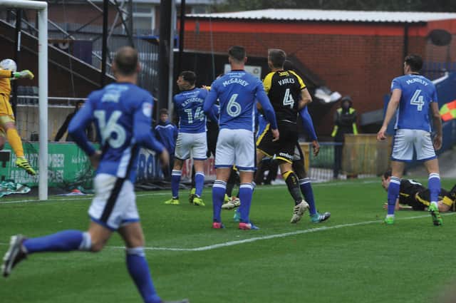 Richard Wood heads the only goal of the game at Rochdale.