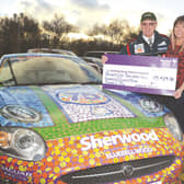 Stuart presenting the proceeds from his period sponsored car to Bluebell Wood's Melanie Rose