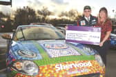 Stuart presenting the proceeds from his period sponsored car to Bluebell Wood's Melanie Rose