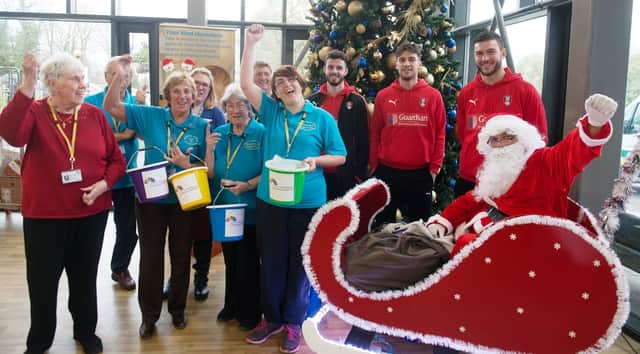 Pictured left to right: Anthony Forde, Joe Newell, and Richard O’Donnell from Rotherham United Football Club with volunteers from The Rotherham NHS Foundation Trust and Santa
