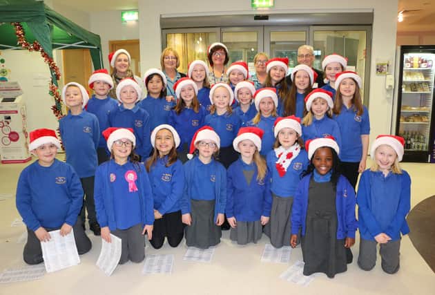The youngsters from St Mary’s Catholic Primary School Choir are pictured with teachers and RDaSH staff.