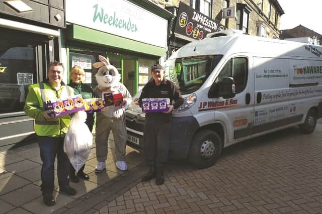 Pictured with the Easter Bunny are, from left: Sean Gibbons, Weekender office manage Karen Mullins and John Gray from JP Walton & Son.