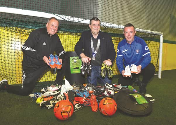 Ronnie Moore Academy manager Bob Sanderson (left) is seen receiving donations from Round Table chairman Matt Ridsdale (centre) and Geoff Swann of Wickersley Youth.