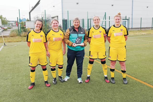 Val Hoyle with her award alongside Rotherham United Women players (left to right) Natalie Shaw, Brady Wild, Amy Pollock and Leanne Carter. Picture by ALEX ROEBUCK