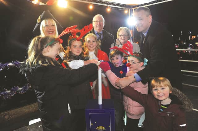 Pushing the plunger to turn on the lights, The Mayor of Rotherham Cllr Eve Rose Keenan, consort, Pat Keenan, The Deputy Mayor amd Mayoress of Rotherham, Cllr and Mrs Alan Buckley and (from left to right), Emily Wright, Isabelle Keenan, Mini Mayor, Hazel Foulger, Riley Hewitt, Sophie Sales and Finlay Aveyard. 171952-13