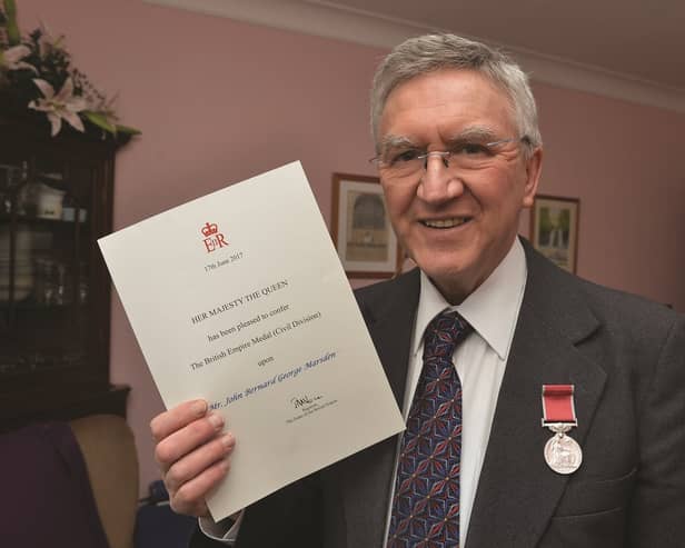John Marsden with his BEM certificate and medal.