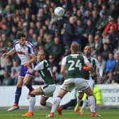 Joe Newell gets a header in during the defeat at Plymouth on Saturday. There will be no return to Home Park in the play-offs.