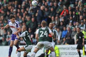 Joe Newell gets a header in during the defeat at Plymouth on Saturday. There will be no return to Home Park in the play-offs.