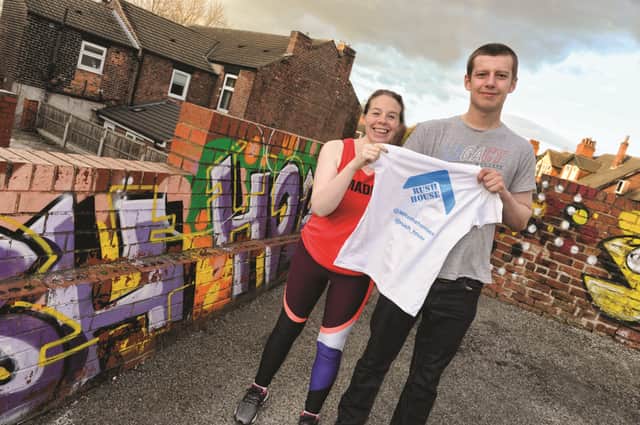 Maddy Corr who is running the London Marathon for Rush House in Rotherham is presented with her running top from resident, Daniel Blades. 190446-1