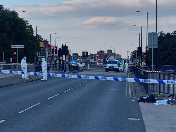Police officers at the scene of the stabbing on Balby Road. Picture: Kerrie Beddows.