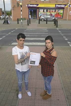 Naomi Saxon (right) and her mum Andrea Adams with the petition, at Knollbeck Lane zebra crossing. 171470-2