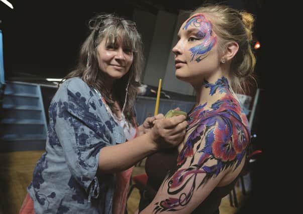 Julia-Marie Harris of Julia Arts demonstrates her body art painting with the help of model Jade Morris. 171492-5