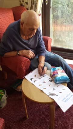 Broadacres Care Home resident and retired GP Michael Viney (87) ticks off the birds spotted in the garden during the RSPB Big Garden Birdwatch.