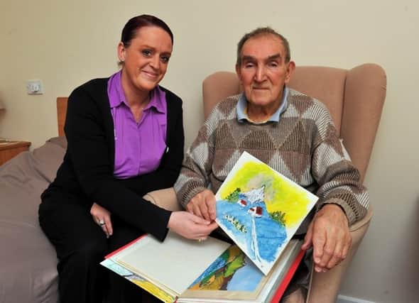 Artist George Robertson and care home deputy manager Louise Cooke