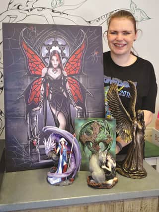 Jordan Mangnall with the work of Anne Stokes, fantasy artist, which is on sale in her shop. 190227-1