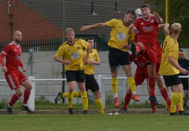 Action from Dinnington Town's recent match against Crowle. Picture by Lewis Parkin.