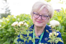 Sally French, RDaSH governor, with one of the special rose bushes