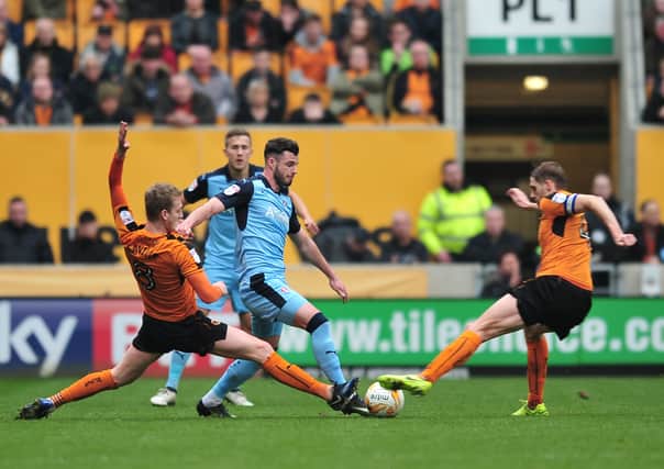 Anthony Forde tussles with Wolves' George Saville and Dave Edwards. Picture: Trevor Price
