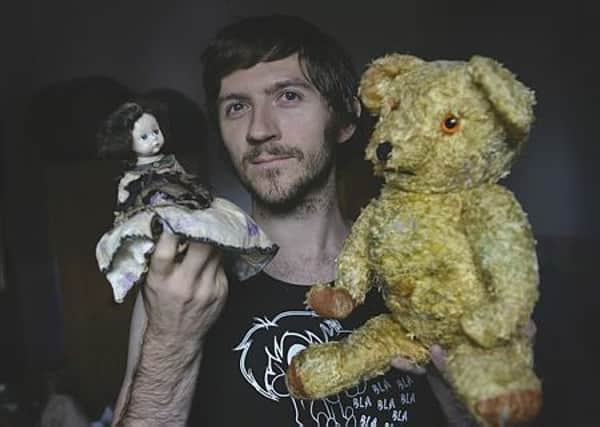 Paranormal investigator Lee Steer with the 'haunted' doll and teddy. 171526-4