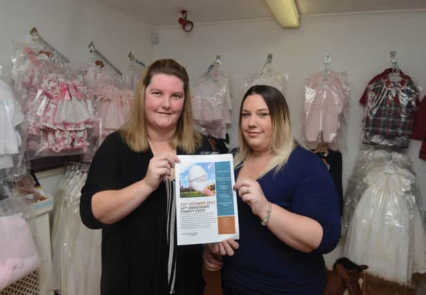 Ashlea Lovell (left) and Michelle Lovell with a poster promoting the 14th anniversary fundriaising event for NeuroCare Sheffield, at her business Ashlea's Baby, Childrens Wear and Accessories at Conisbrough. 171633
