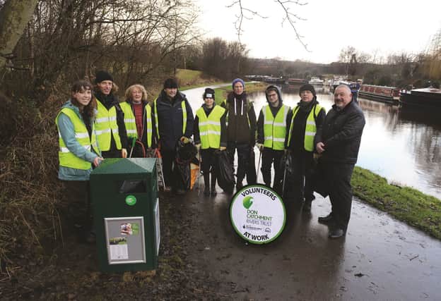Pictured are community engagement officer Sally Hyslop (left), project co-ordinator for Love Where You Live Wayne Munro-Smith (right) and members of the volunteer team. 180074.