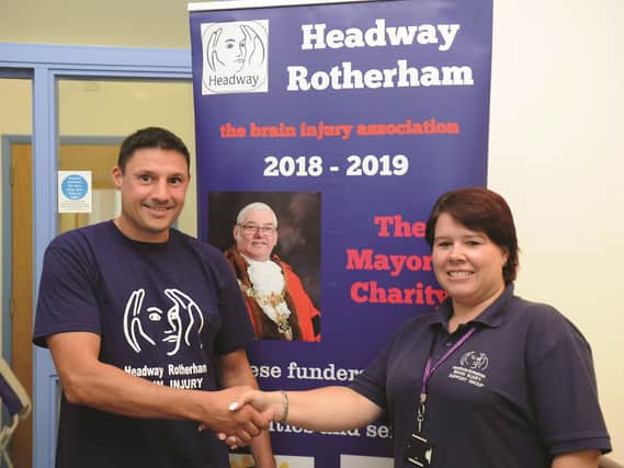 Neil Etchell being wished 'Good Look' by Sadie Bratt, community development and engagement manager at Headway.