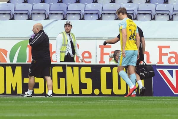 Sean Raggett suffers his injury at Wigan