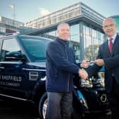 Mike Tyson, managing director of Guy Salmon Land Rover Sheffield (L), hands the Discovery’s keys to Chris Tobin, head of estates services (R).