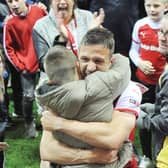 Richard Wood hugs son Jenson after the final whistle