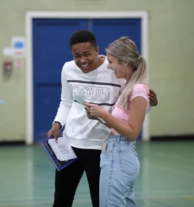 Asher Greatorex and Katie Wright celebrate picking up their GCSE results. PICS: Alex Roebuck.