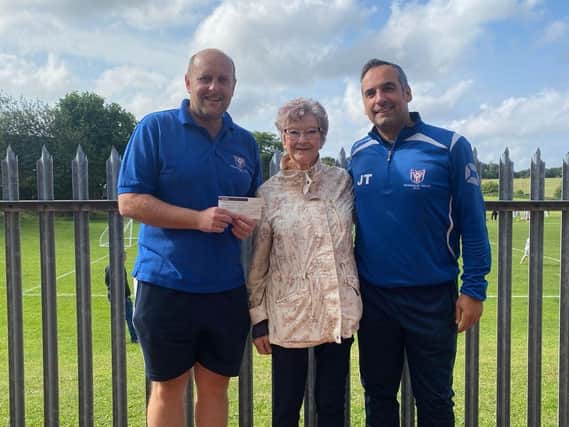 Margaret Bower presenting her cheque to vice-chairman Joe Trozzo and Simon Lilley, club treasurer.