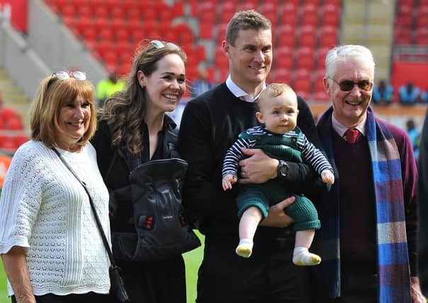 Matt Taylor on the New York Stadium pitch with his family on the day safety was secured. Picture by Kerrie Beddows