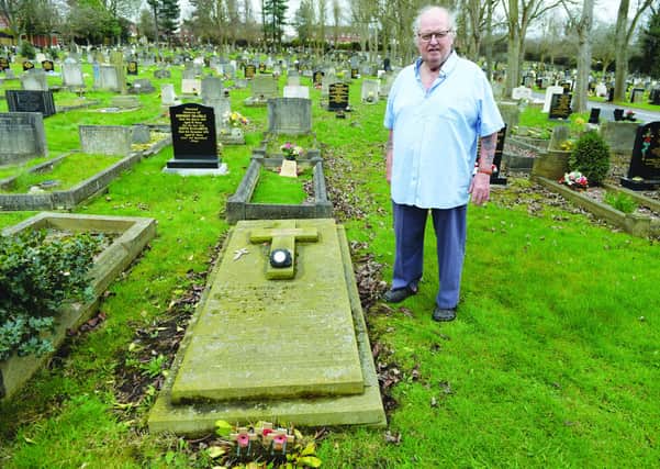 Bill Spilsbury at the grave of the unknown miner at Maltby Cemetery.