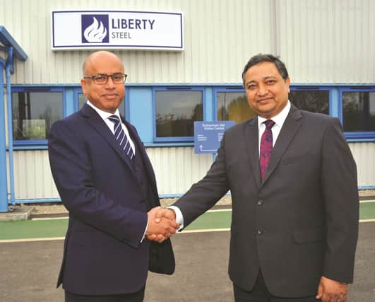 Chief executive of Tata Steel UK, Bimlendra Jha (right) shakes hands with executive chairman of Liberty House Group, Sanjeev Gupta, to officially hand over the plant to new owners Liberty Steel. 170720-4