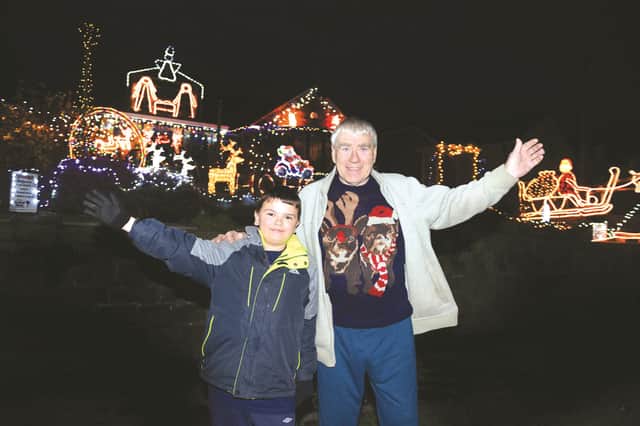 Martin Smith and his grandson Ryan Hobson turned on the Christmas lights at Martin's Swinton home, to raise funds for Bluebell Wood Children's Hospice. 172057-1